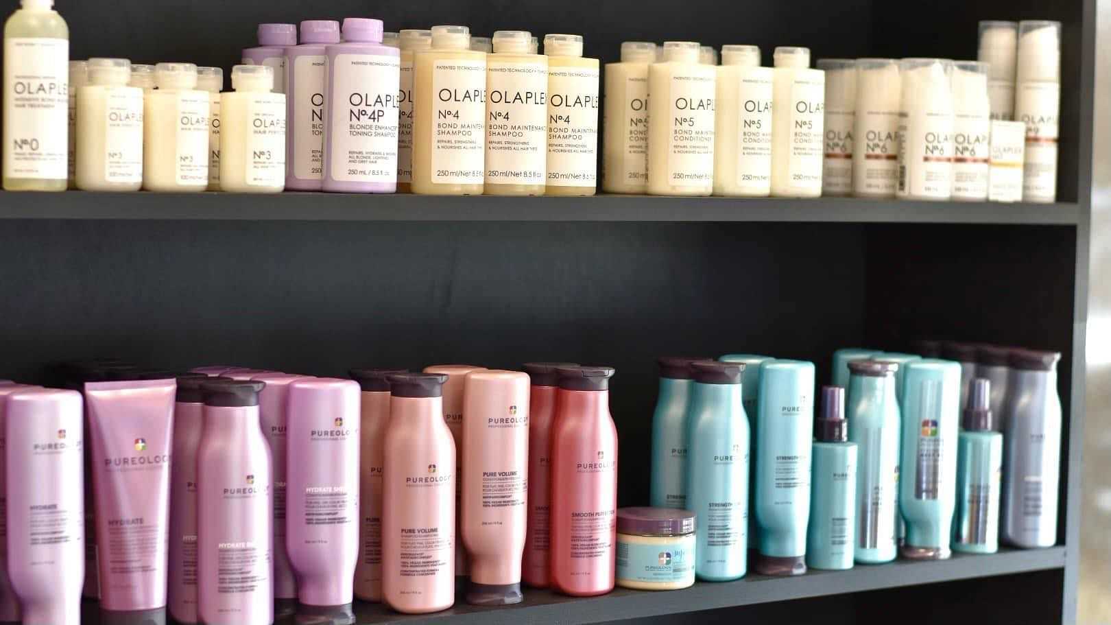 Shelves with various bottles of Olaplex hair products in different sizes and colors.